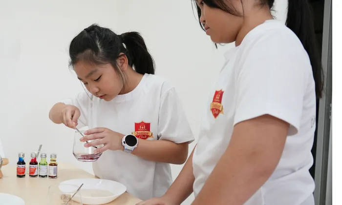 Students working together happily on an activity at Maple Bear Junior Club Eunos