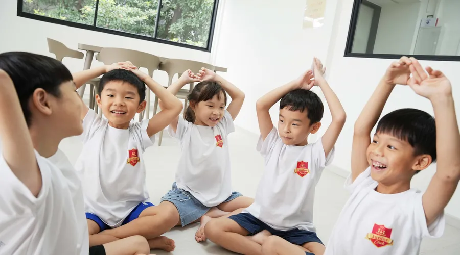 Children expressing themselves confidently in a group activity at MJC Eunos